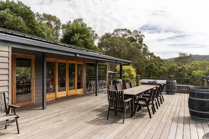 Outdoor table on a timber deck among trees