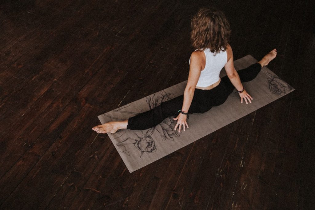 A woman practising yoga in a calm studio setting.